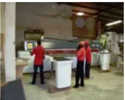 Craftsmen operating CNC machines in the furniture factory