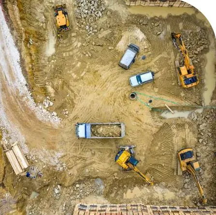 Aerial view of road earthworks with trucks and excavators
